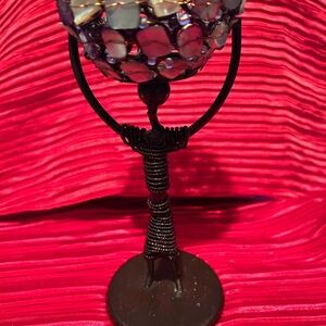 African stir of a man holding an abalone and wire basket over his head- preloved